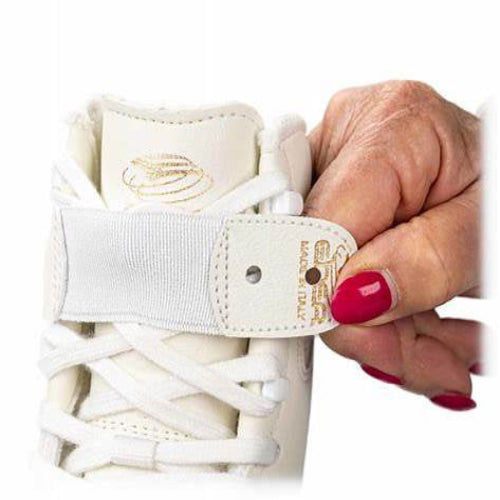 a lady hand wearing red polish holding a edea figure skating lace strap tab