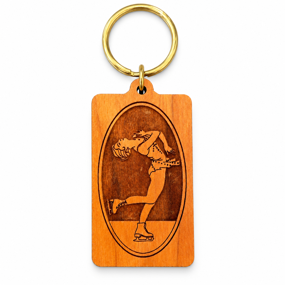 Wooden rectangular figure skating keychain with engraved layback spin design and gold-tone key ring on white background